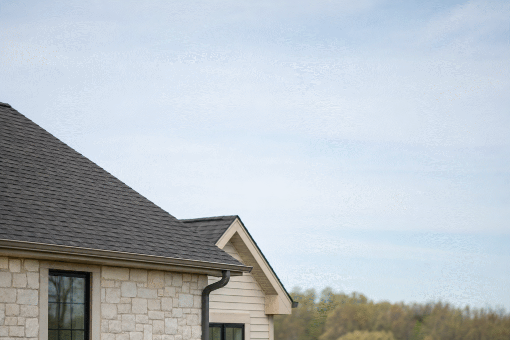 Well-kept residential property with finished roofing work and clear open sky